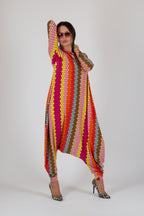 Person wearing a colorful, patterned outfit on a white background
