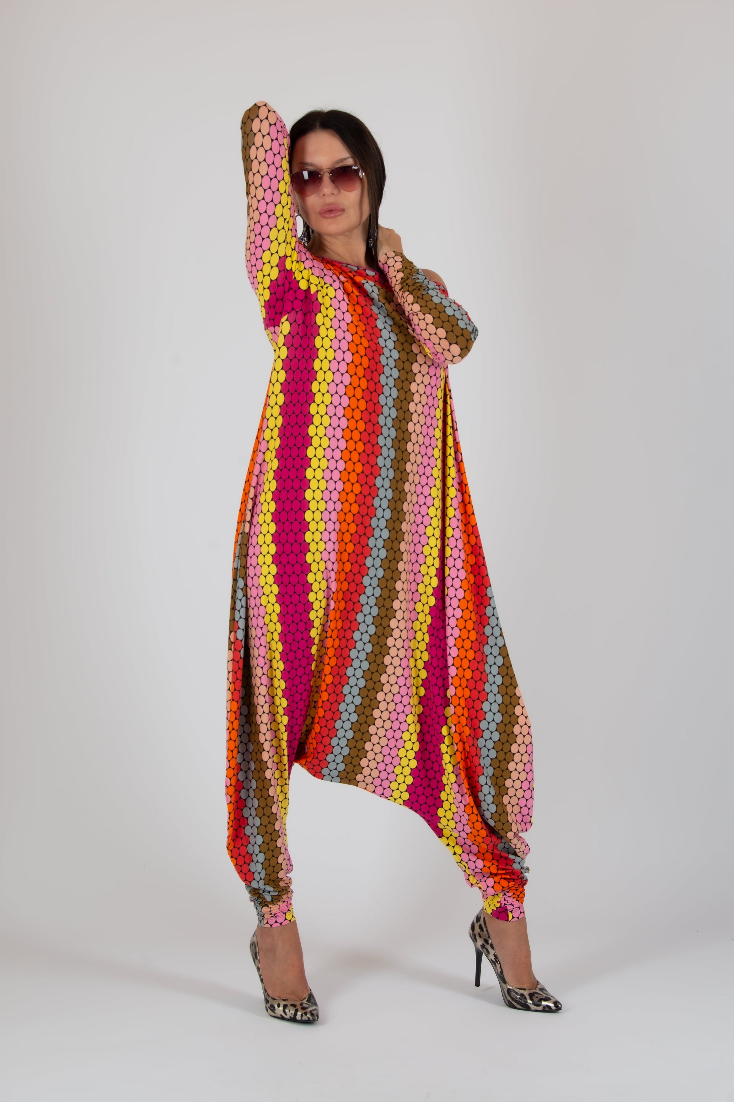 Person wearing a colorful, patterned outfit on a white background