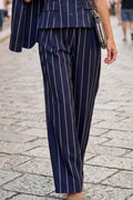 Navy pinstripe suit on a person walking on a cobblestone street
