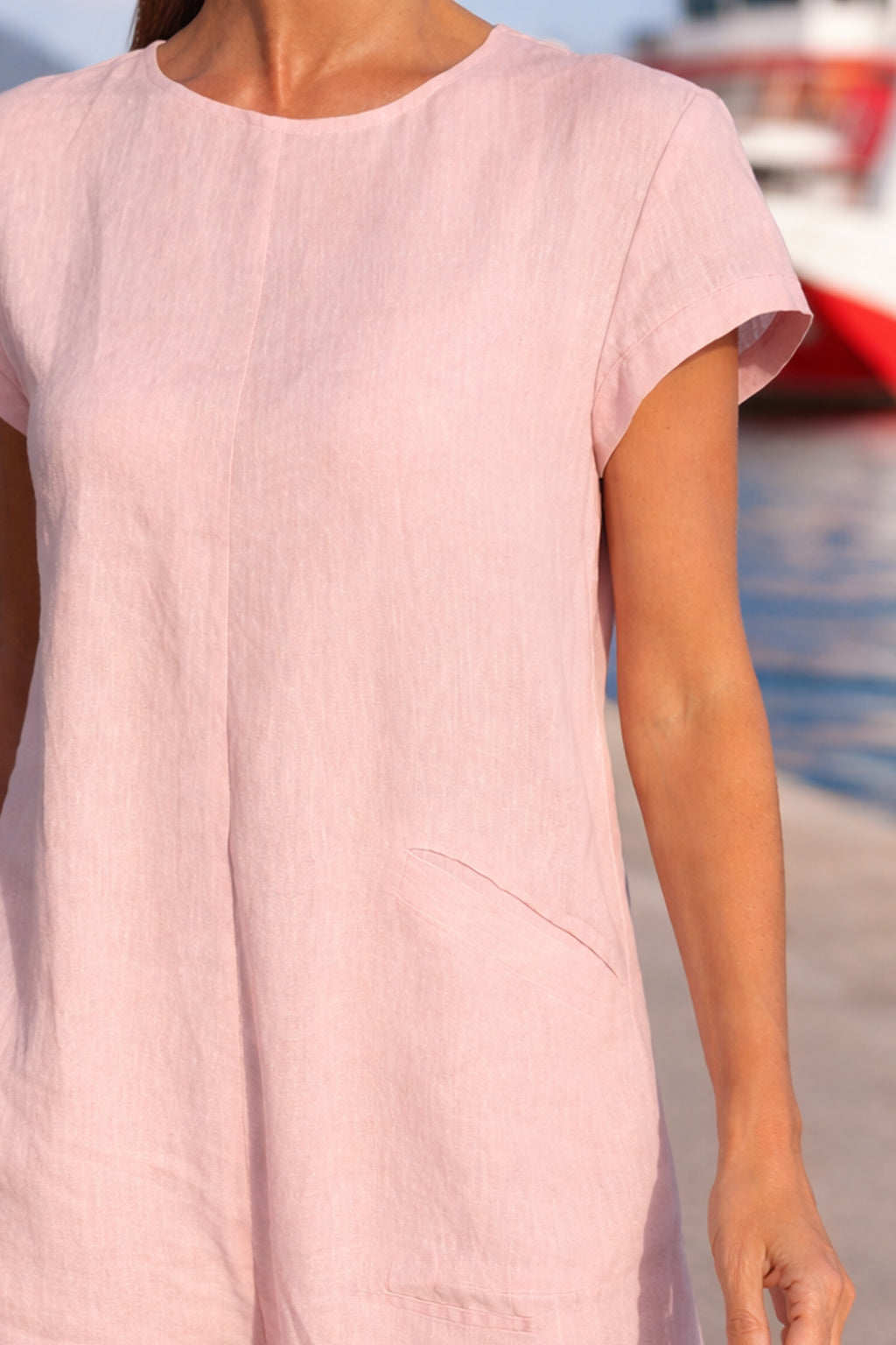 Person wearing a light pink jumpsuit 