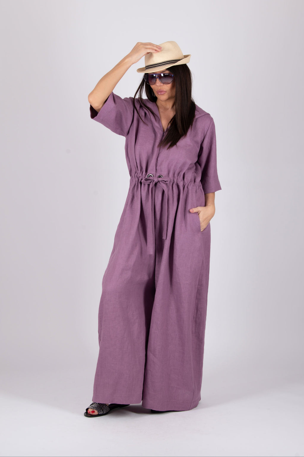 Woman wearing a purple wide jumpsuit 