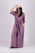 Woman wearing a purple wide jumpsuit 