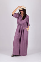 Woman wearing a purple wide jumpsuit 