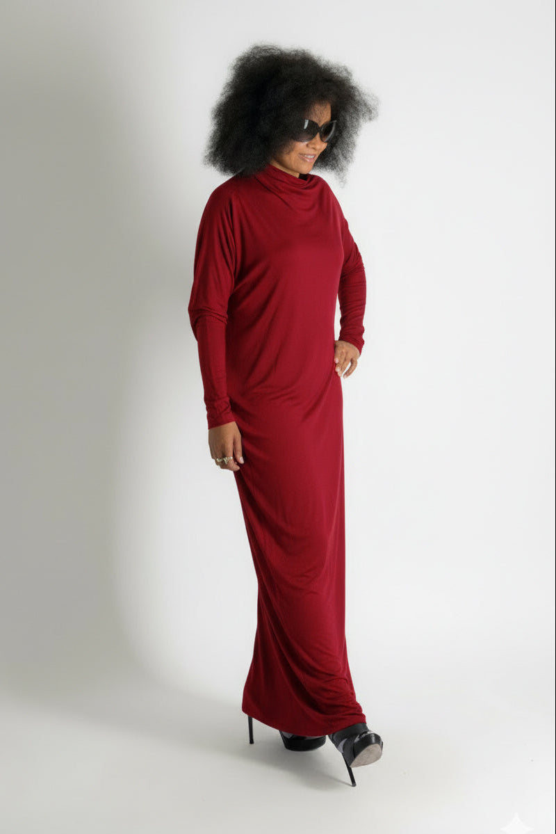 Person wearing a long red dress on a white background