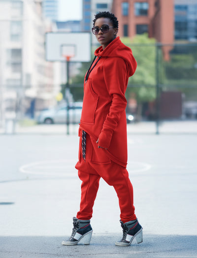 Person wearing a red tracksuit with sunglasses in an urban setting EugFashion 