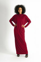 Woman wearing a long red dress on a white background