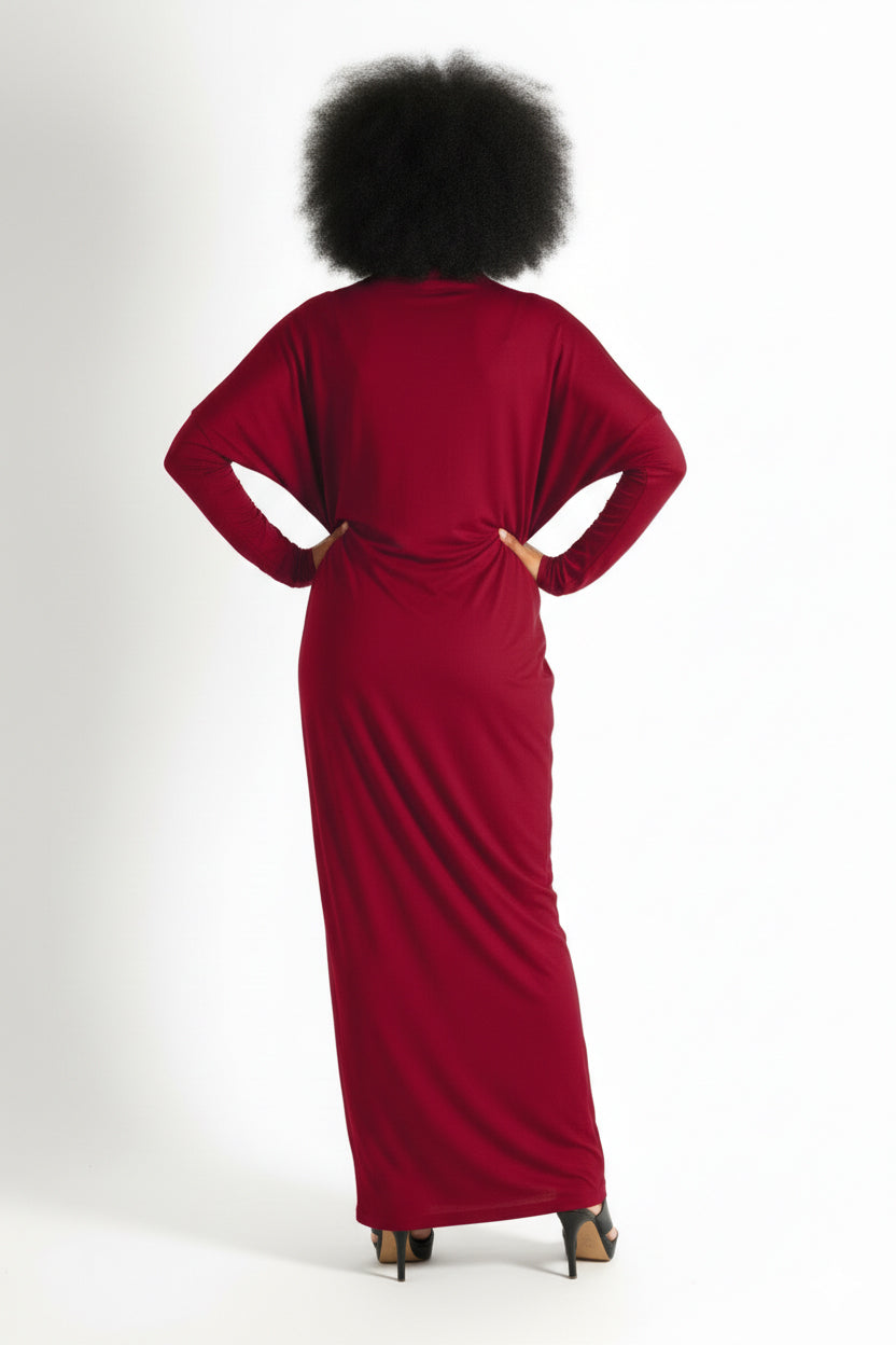 Person wearing a red dress with their back to the camera on a white background