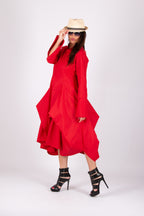 Woman wearing a red dress, black high-heeled shoes, and a beige hat on a white background