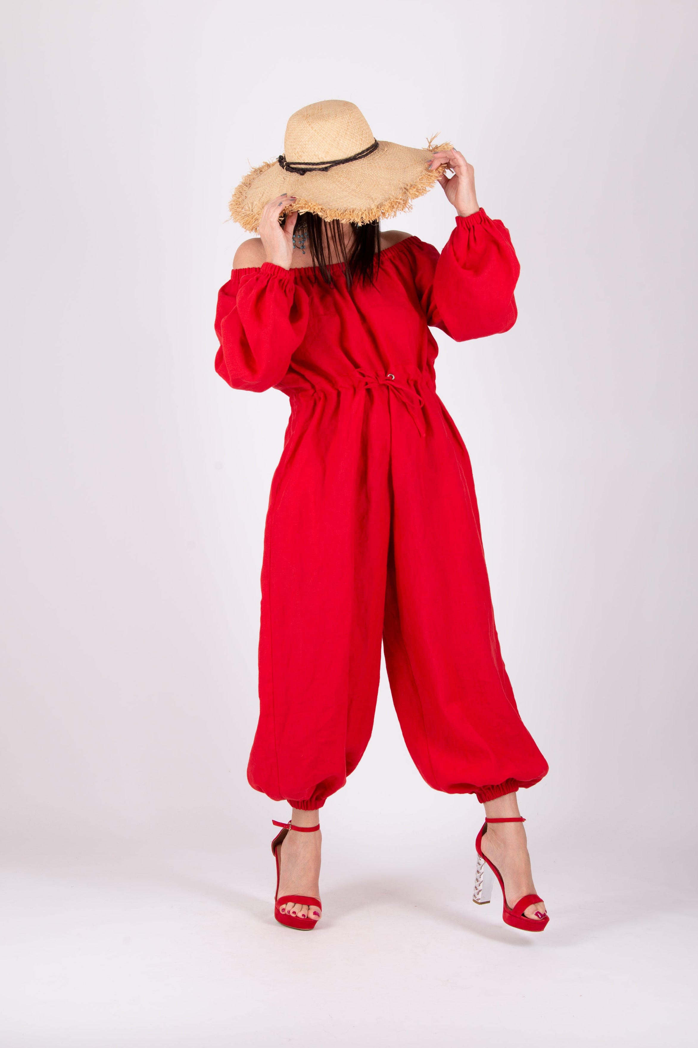 Person wearing a red outfit and straw hat on a white background