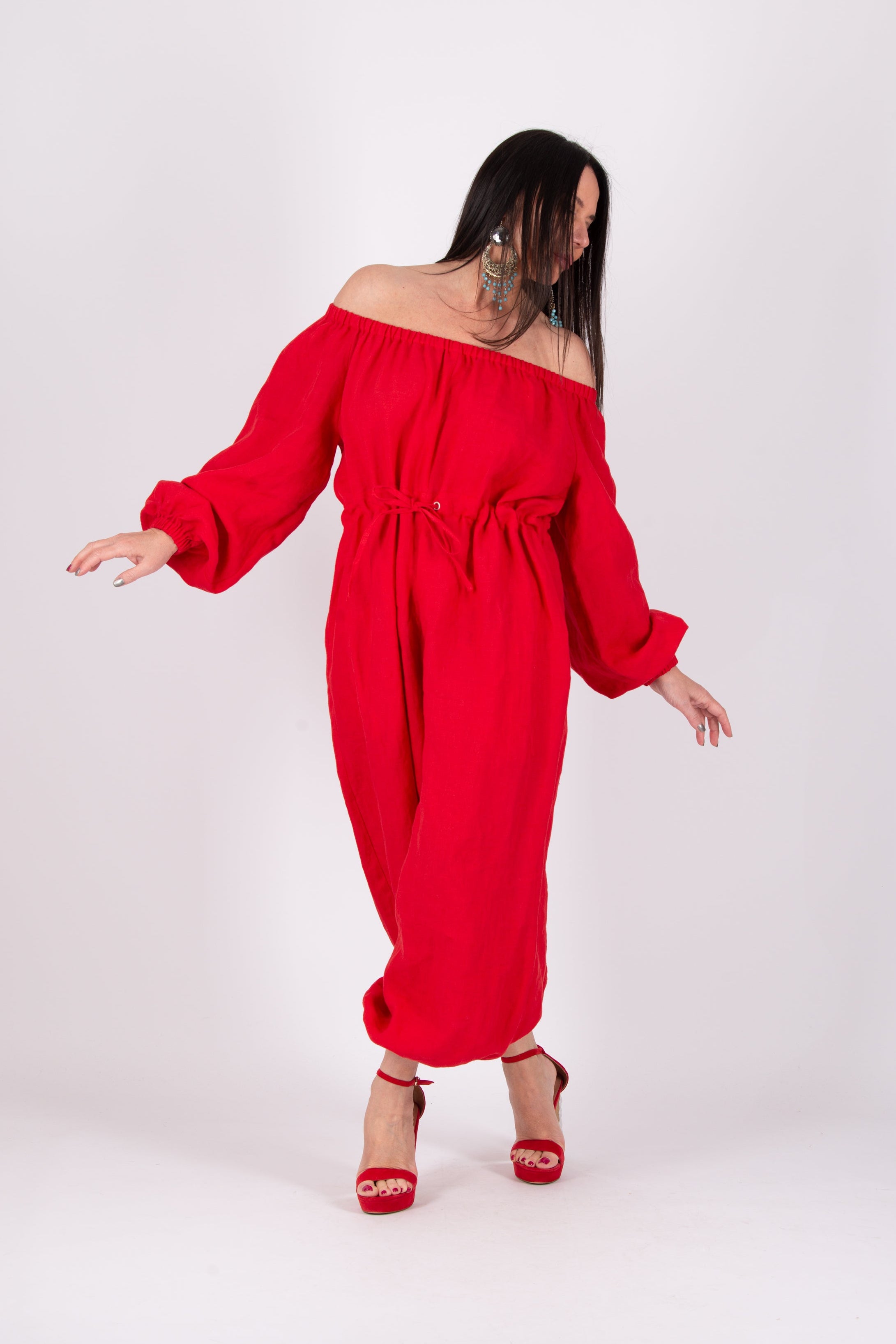Woman wearing a red off-shoulder dress on a white background