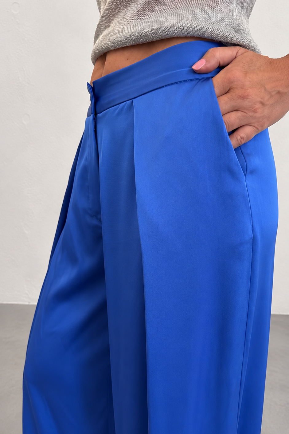 Blue pants worn by a person against a neutral background