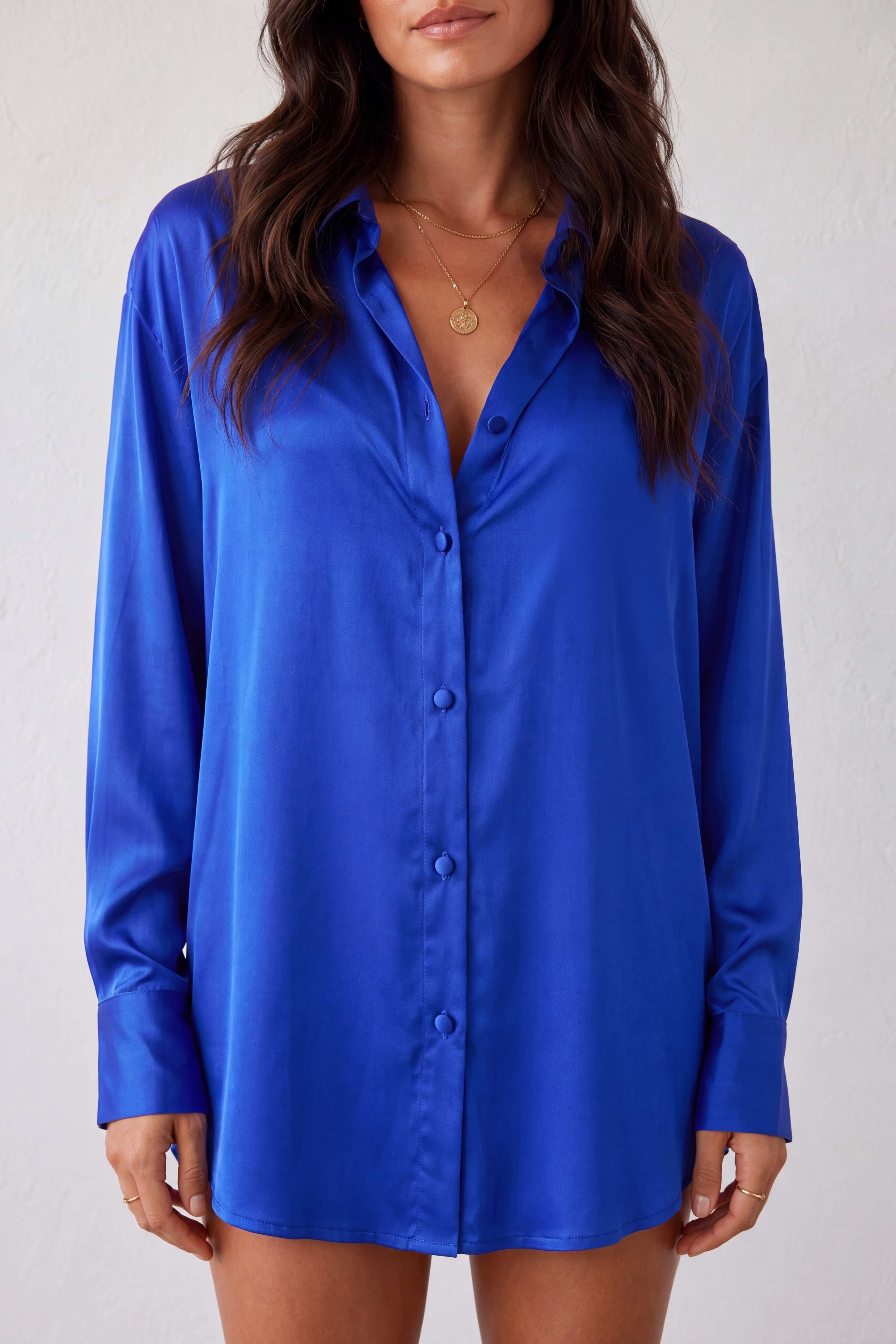 Woman wearing a blue satin shirt  loose fit