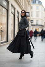 Woman in a black outfit walking on a city street