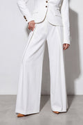 White suit with wide-leg pants on a plain background