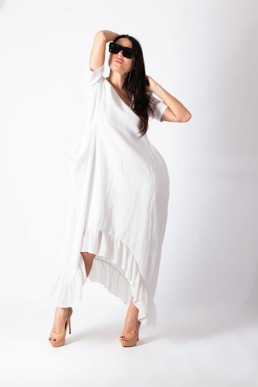 Woman wearing a white dress with a plain background