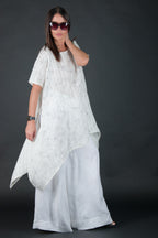 Woman wearing a white dress with a dark background