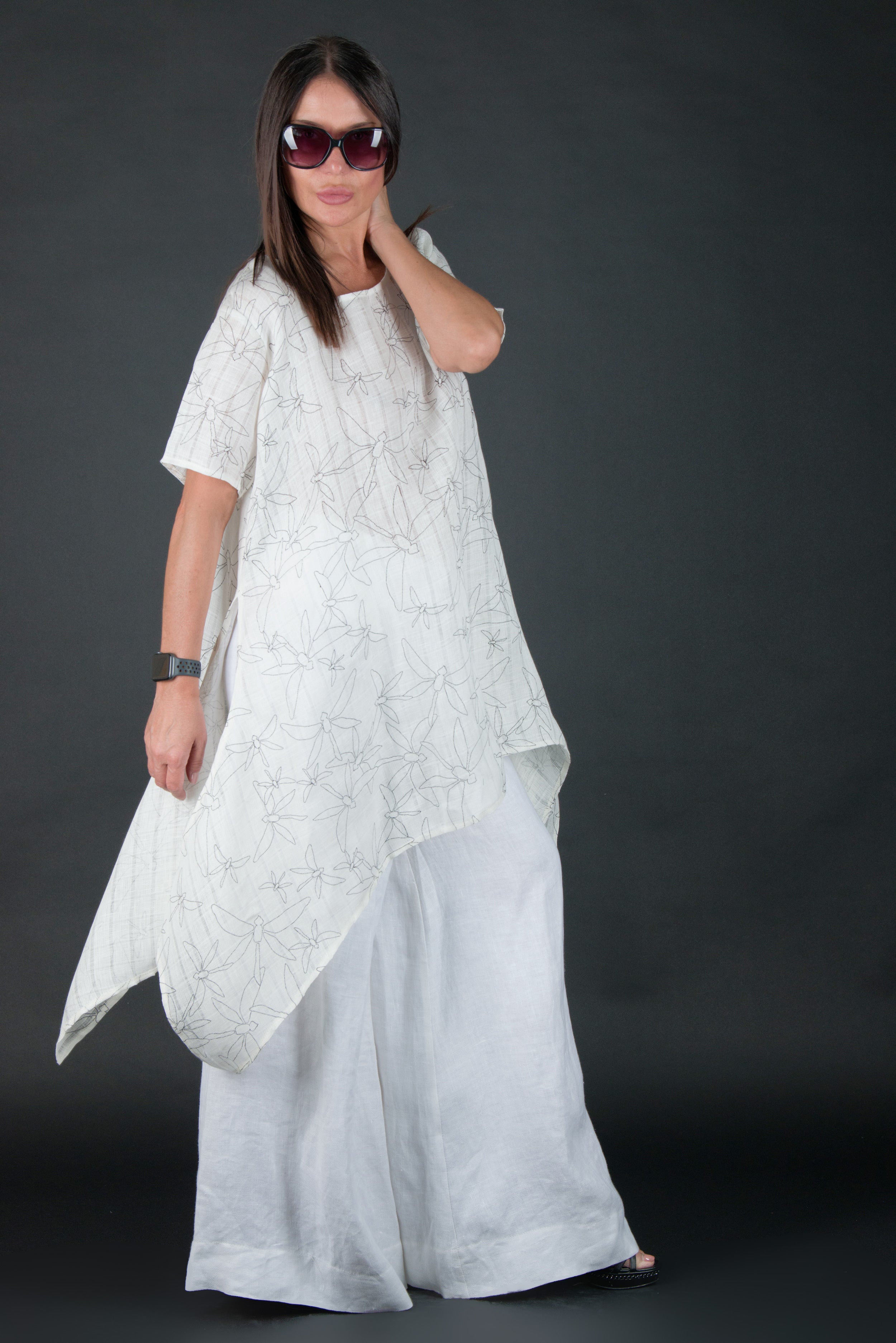 Woman wearing a white dress with a dark background