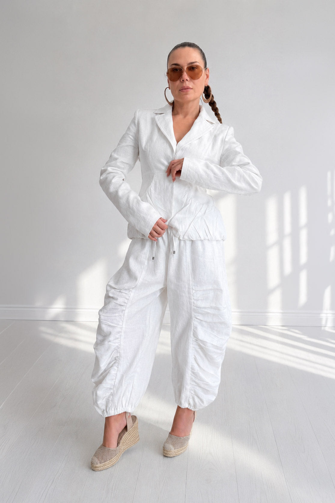 Woman wearing a white outfit in a bright room
