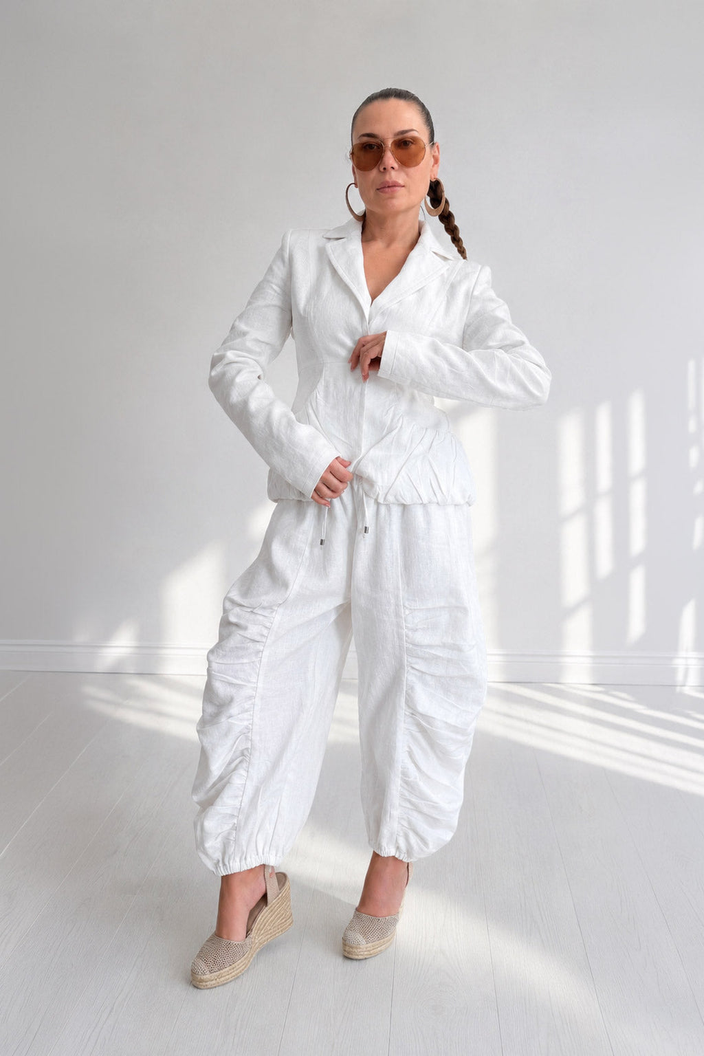 Woman wearing a white outfit in a bright room