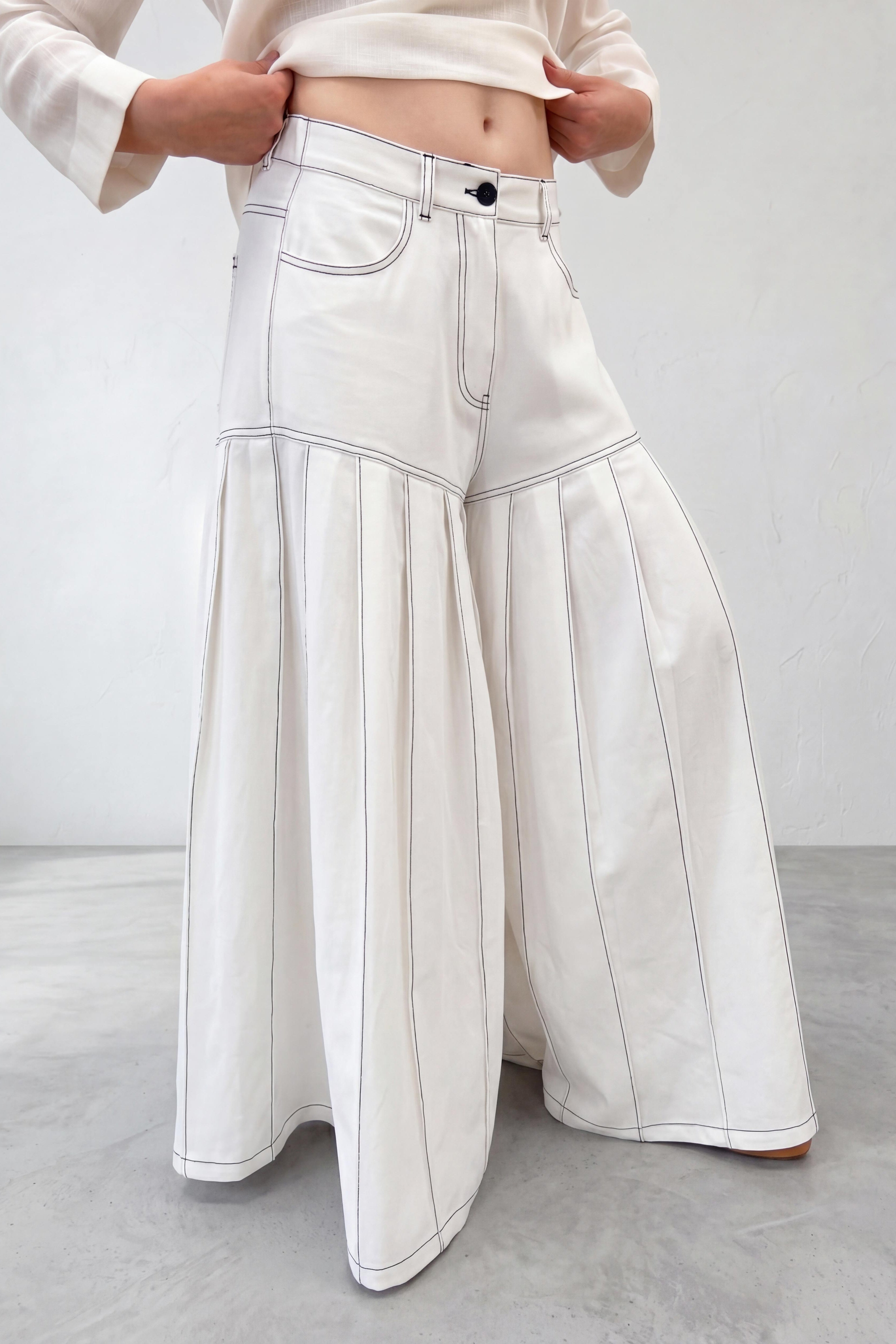 White wide-leg pants worn by a person on a plain background
