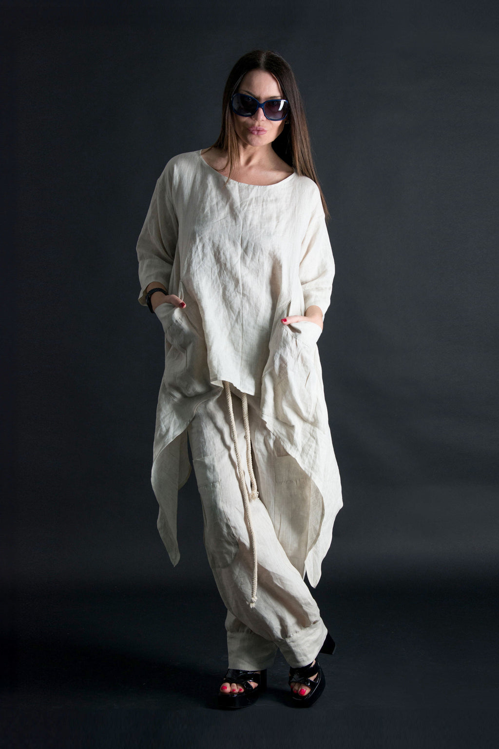 Woman wearing a natural linen outfit against a black background