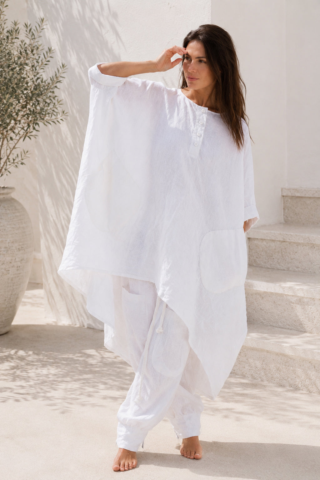 Woman wearing a white linen outfit  from eug fashion