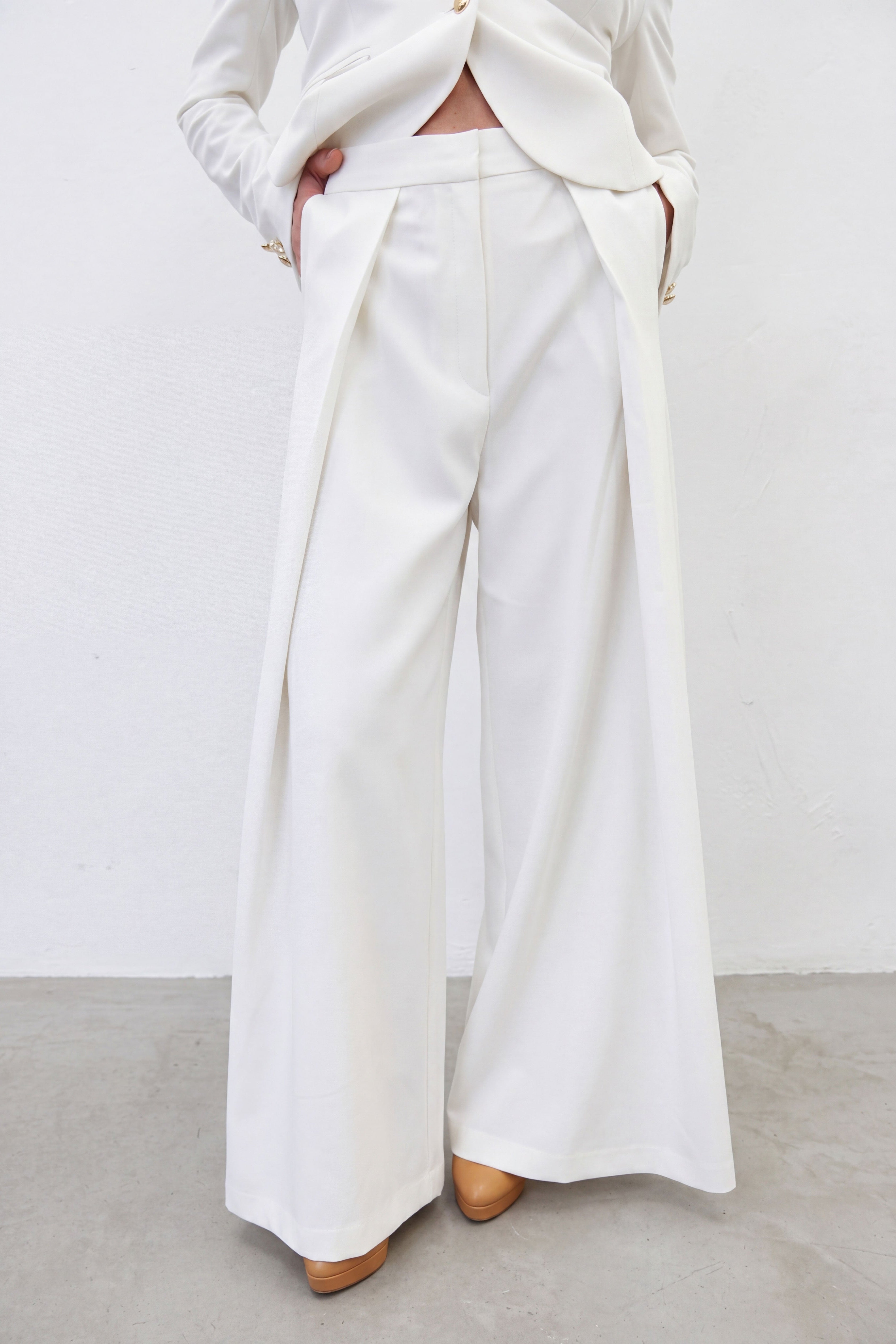White outfit with wide-leg pants on a plain background