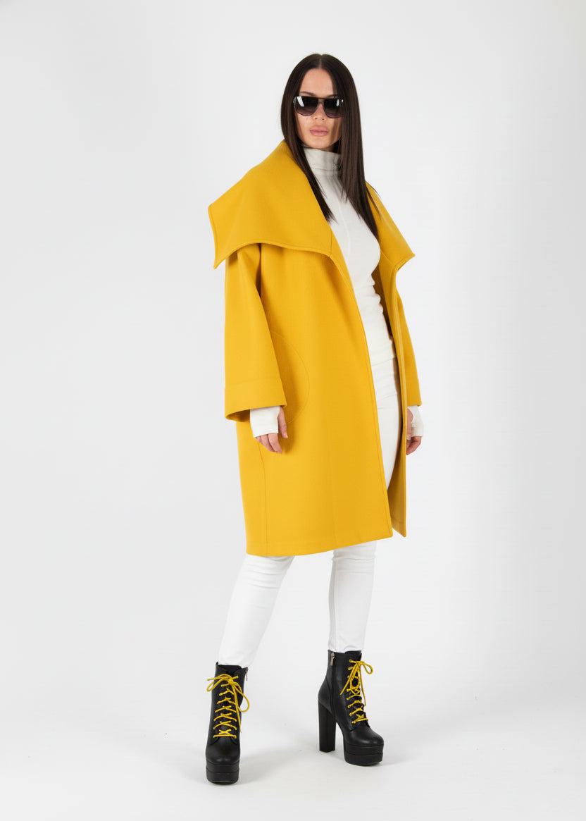 Person wearing a mustard yellow coat on a white background